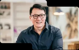 Smiling business professional in a smart navy shirt, with glasses, exuding expertise and approachability, reflective of the customer-focused service at our cryptocurrency exchange.