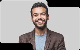 Enthusiastic young male team member with a friendly demeanor, wearing a brown blazer and light blue sweater, showcasing the dynamic and approachable team culture of our cryptocurrency exchange.